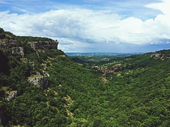 Scenic view of landscape against cloudy sky