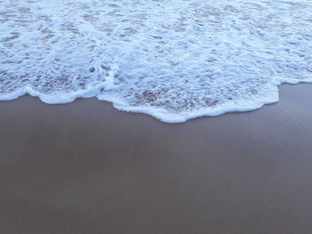 High angle view of surf on beach