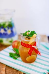 Homemade apple jam in glass jar on table