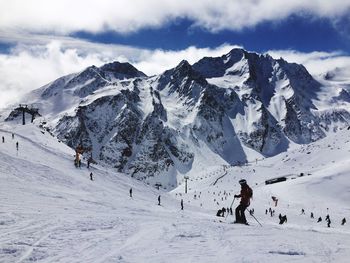 People skiing on snow covered landscape