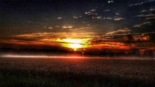 Scenic view of field against sky during sunset