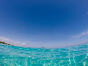 Scenic view of sea against blue sky