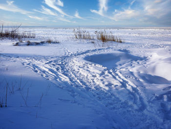 Scenic view of snow covered landscape against sky