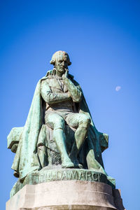 Low angle view of statue against blue sky