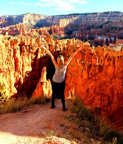 Full length of woman standing on rock formation