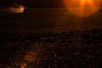 Man in illuminated field at night