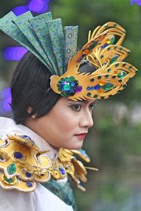 Side view of thoughtful woman in traditional clothing during festival