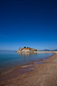 Scenic view of sea against clear blue sky