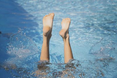 Low section of woman in swimming pool