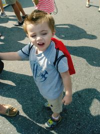 Low section of boy standing on road