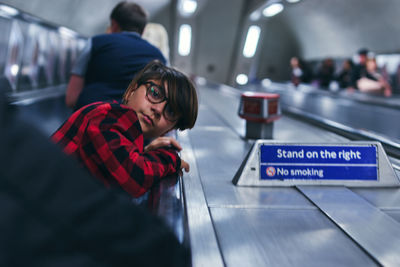 Portrait of boy leaning on railing