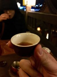 Close-up of hand holding tea cup