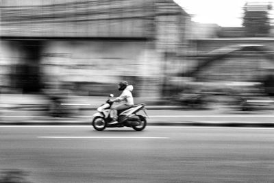 Man riding motorcycle on street