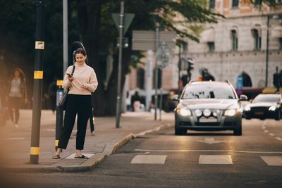 Man standing on street in city