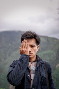 Portrait of young man standing outdoors