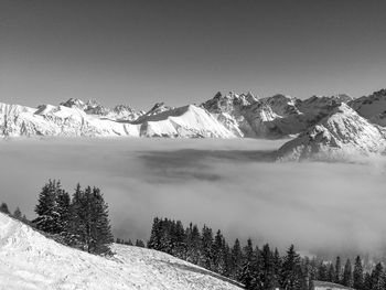 Scenic view of snow covered mountains against sky