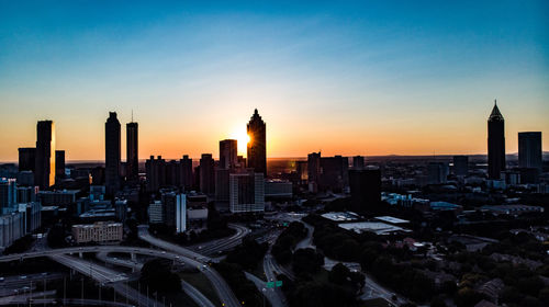 View of buildings in city at sunset