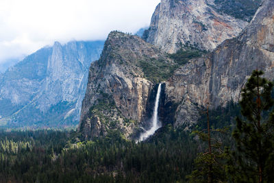 Scenic view of waterfall against sky