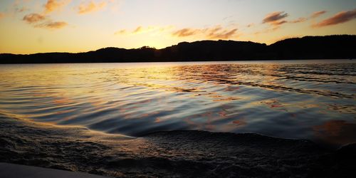 Scenic view of lake against sky during sunset