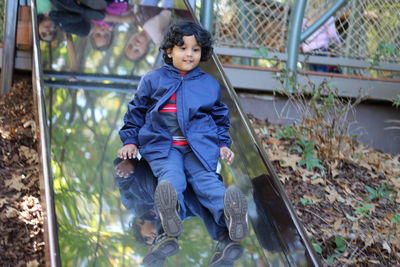 Child on slide in autumn