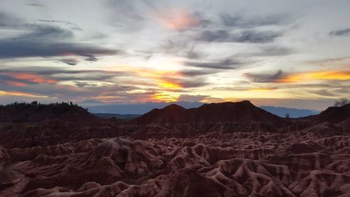 Scenic view of mountains against cloudy sky