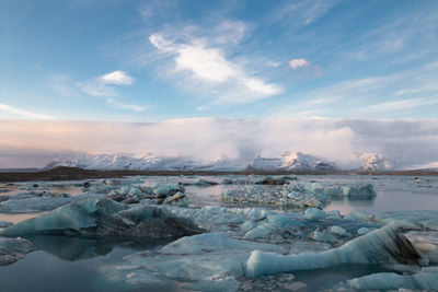 Scenic view of lake against sky during winter