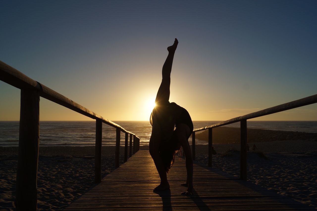 railing, sunset, sea, water, clear sky, silhouette, one person, nature, sky, adults only, outdoors, horizon over water, bridge - man made structure, scenics, one man only, beauty in nature, people, adult, only men, day