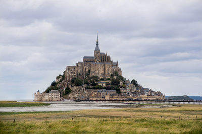 Historic building against cloudy sky