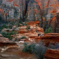 Low angle view of people on rock formations