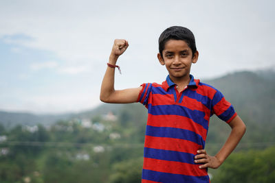 Portrait of smiling boy standing outdoors