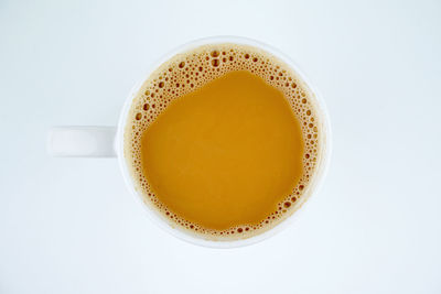 Directly above shot of coffee on table against white background