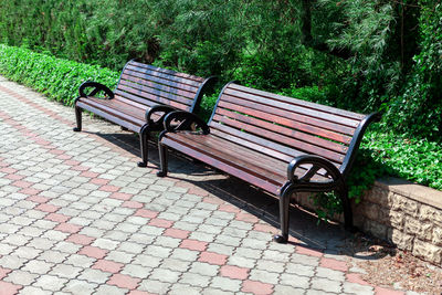 Wooden benches and pavement . empty seats in the park