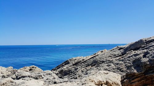 View of calm blue sea against clear sky