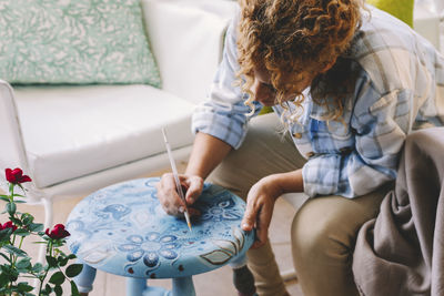 High angle view of woman painting at home