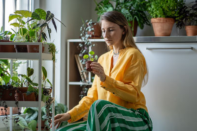 Side view of young woman using mobile phone