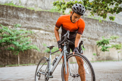 Athlete checking bicycle wheel