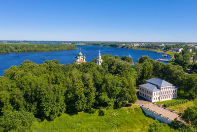 High angle view of trees and buildings against clear sky