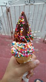 Close-up of hand holding ice cream cone