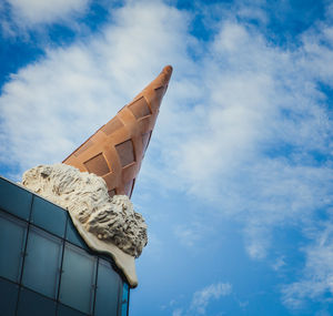 Low angle view of sculpture against blue sky