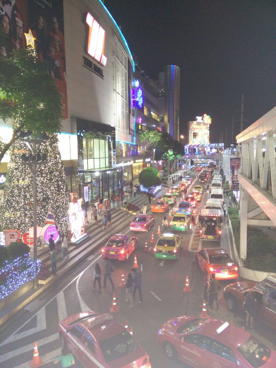 building exterior, architecture, city, built structure, illuminated, street, night, city street, high angle view, road, car, city life, transportation, land vehicle, traffic, residential building, building, road marking, street light, cityscape