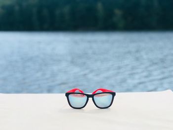 Close-up of eyeglasses on sunglasses at beach