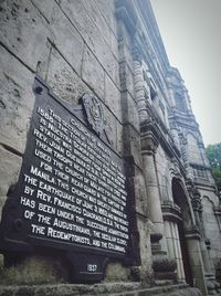Low angle view of text on old building