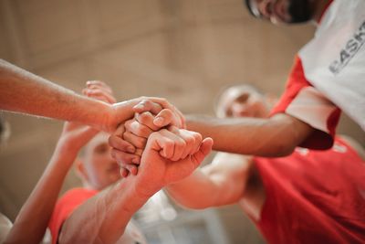 Midsection of people holding hands