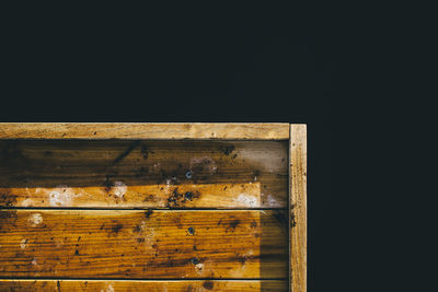 Detail shot of cropped wooden object over black background