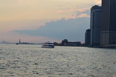View of sea and buildings against sky during sunset