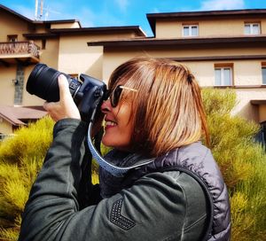 Side view of woman photographing