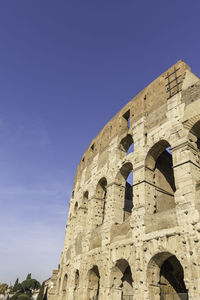 Low angle view of historical building against blue sky