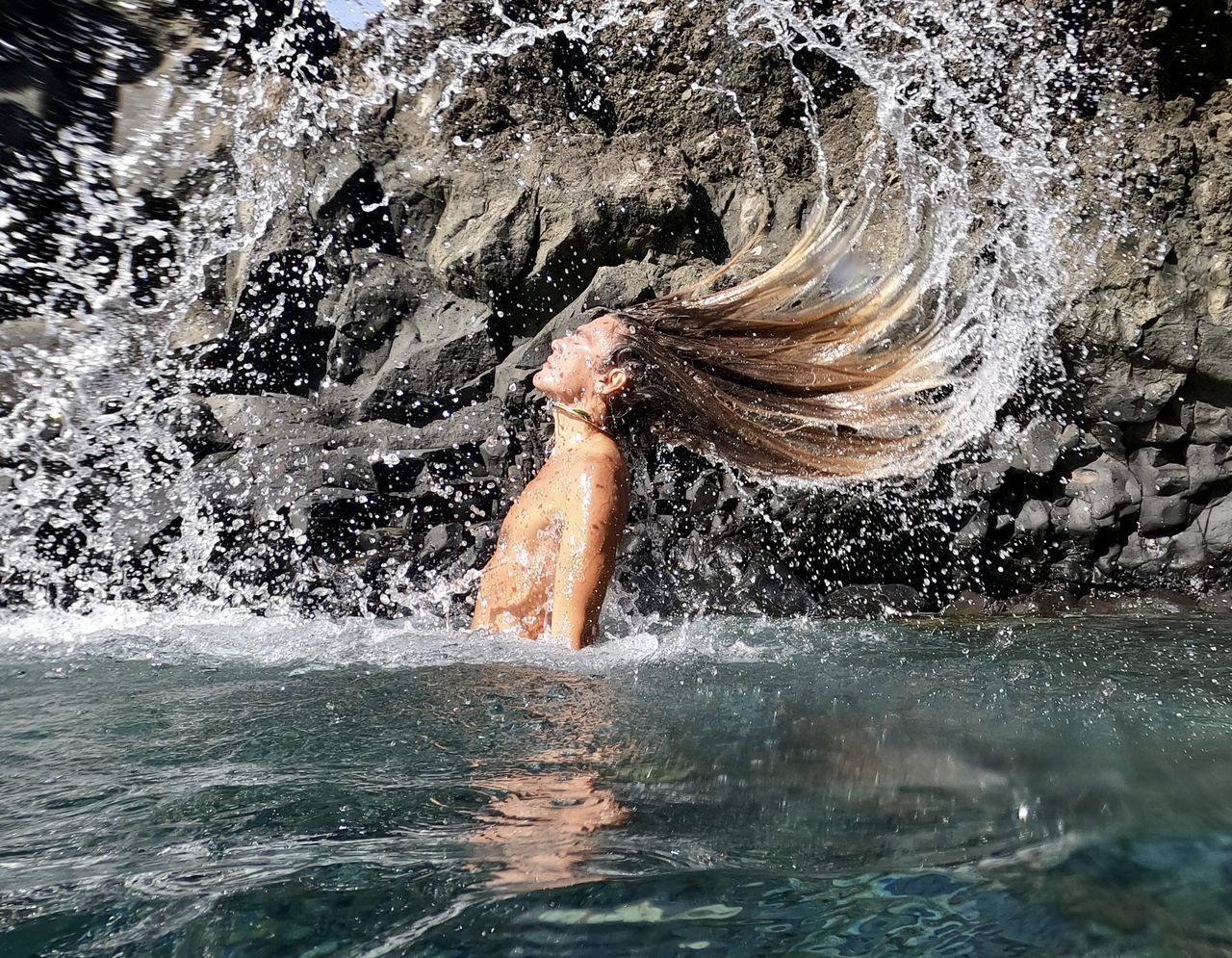 WOMAN SWIMMING IN SEA WATER