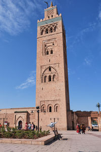 Low angle view of clock tower against blue sky