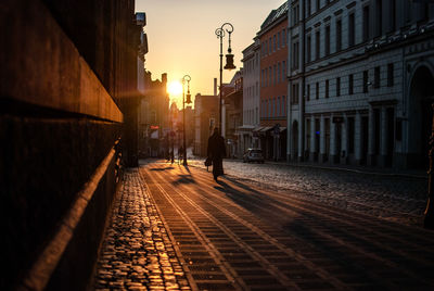 Man on street in city at sunset